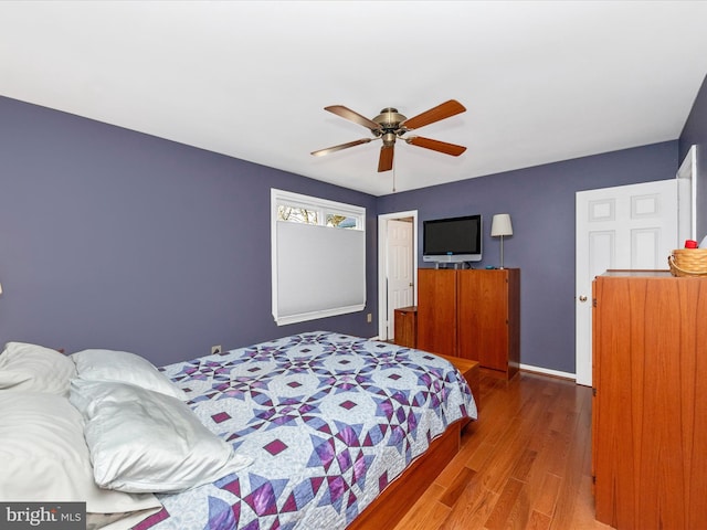 bedroom with wood-type flooring and ceiling fan