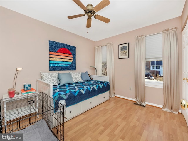 bedroom with wood-type flooring and ceiling fan