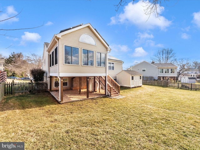 rear view of house featuring a lawn and a storage unit