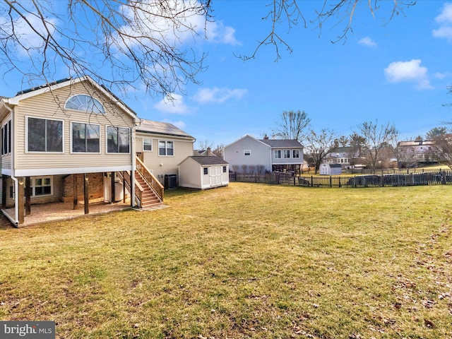 back of property with cooling unit, a lawn, a shed, and a patio area