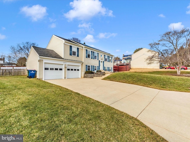 view of front of home with a garage and a front lawn