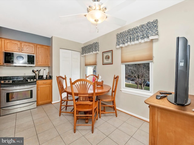 dining space featuring ceiling fan and light tile patterned flooring