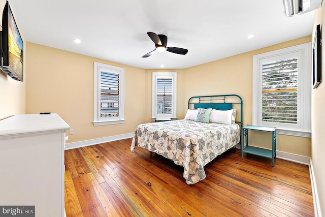 bedroom with hardwood / wood-style flooring and ceiling fan