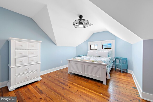 bedroom featuring hardwood / wood-style floors and vaulted ceiling