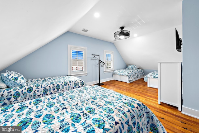 bedroom with lofted ceiling and light hardwood / wood-style flooring