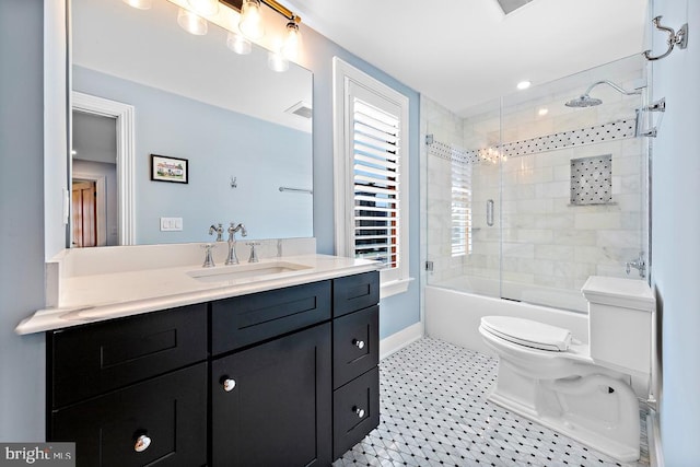 full bathroom featuring vanity, tile patterned floors, toilet, and combined bath / shower with glass door