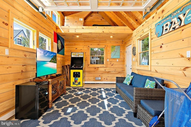 living room with lofted ceiling, carpet floors, and wood walls