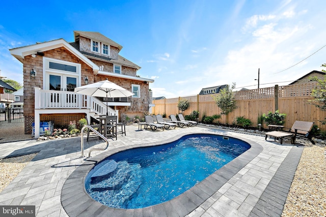 view of swimming pool featuring a patio area and french doors