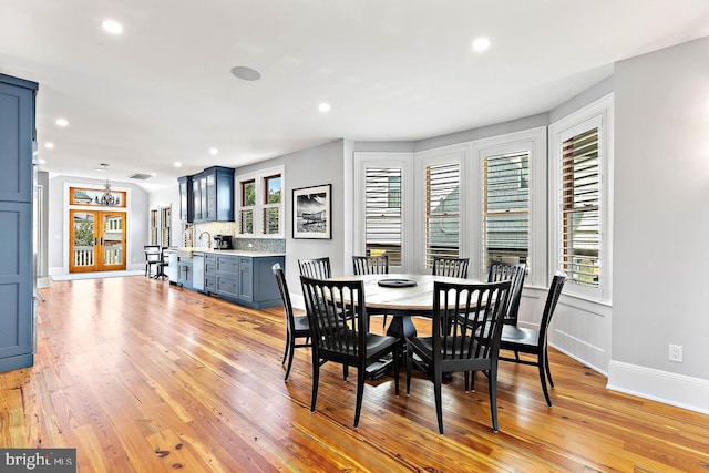 dining room featuring plenty of natural light and light hardwood / wood-style floors