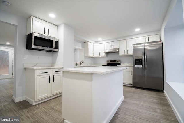 kitchen with white cabinetry, appliances with stainless steel finishes, and a center island