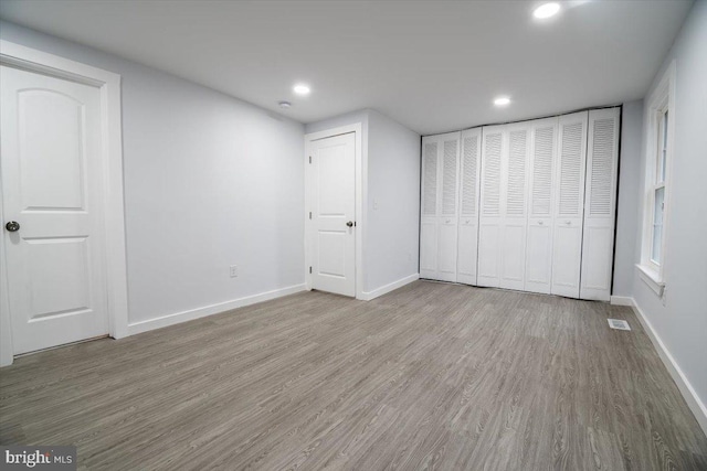 unfurnished bedroom with hardwood / wood-style floors