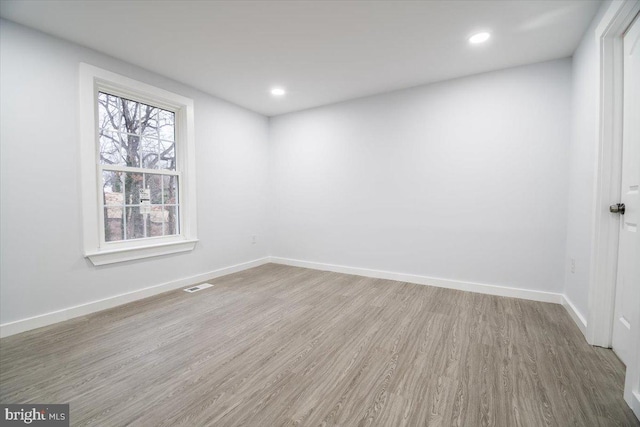 spare room with hardwood / wood-style floors