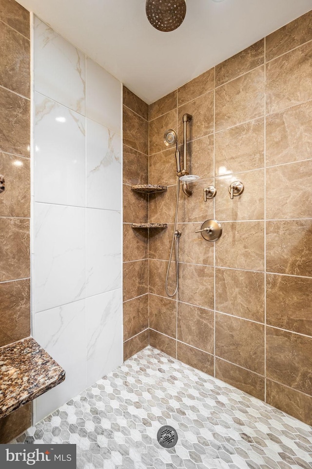 full bath with a tile shower