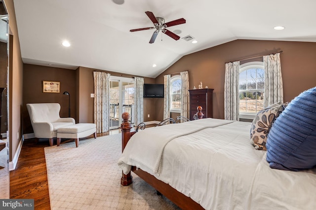 bedroom with baseboards, visible vents, ceiling fan, dark wood-style flooring, and vaulted ceiling