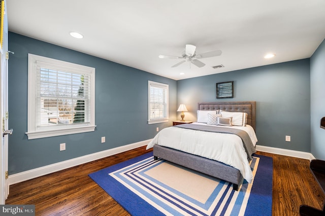 bedroom featuring baseboards, visible vents, and dark wood finished floors