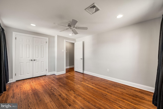 unfurnished bedroom with recessed lighting, dark wood-style flooring, visible vents, and baseboards