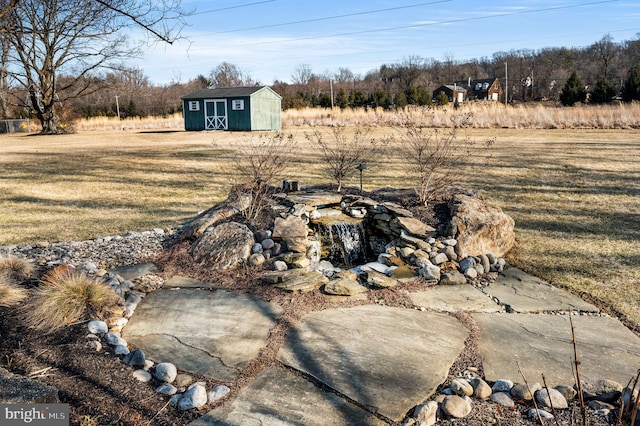 view of yard with a storage shed and an outdoor structure