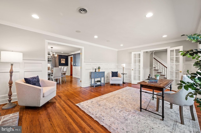 living area featuring visible vents, wainscoting, wood finished floors, french doors, and recessed lighting