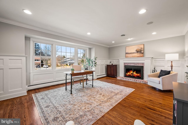 office featuring ornamental molding, dark wood-type flooring, a baseboard radiator, and a brick fireplace