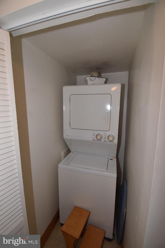 laundry area with stacked washer and clothes dryer