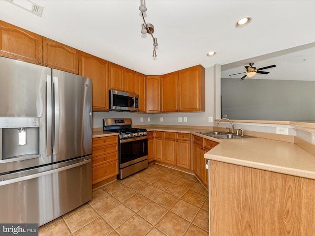 kitchen featuring sink, light tile patterned floors, ceiling fan, and appliances with stainless steel finishes