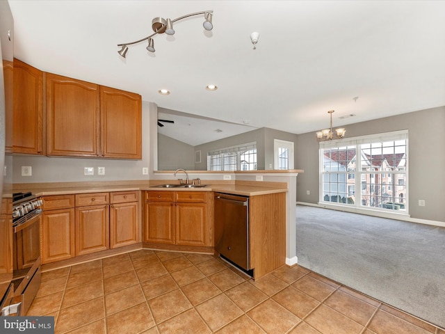 kitchen with decorative light fixtures, sink, kitchen peninsula, stainless steel appliances, and light carpet