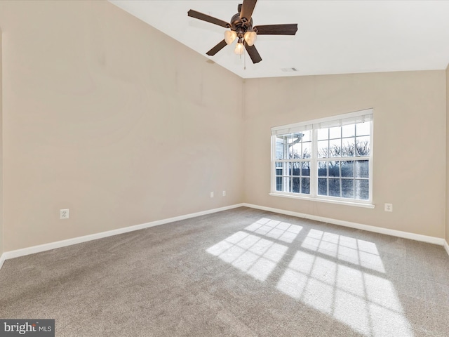 carpeted empty room with ceiling fan and lofted ceiling