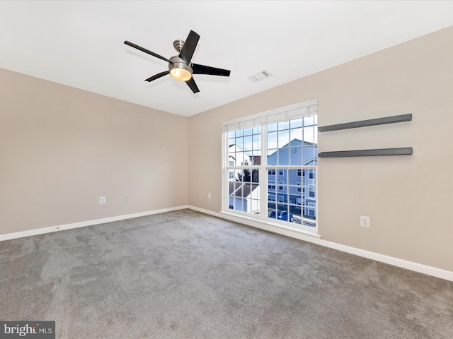 empty room with ceiling fan and carpet