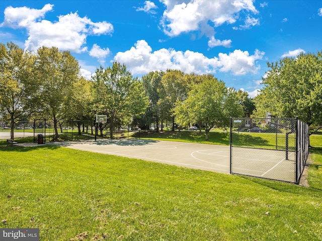 view of sport court featuring a yard