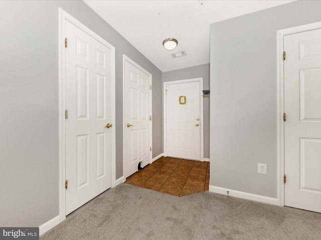 foyer entrance with light carpet