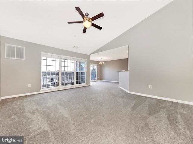 unfurnished living room featuring ceiling fan with notable chandelier, high vaulted ceiling, and carpet flooring