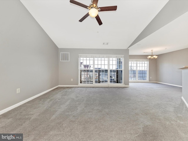 unfurnished living room featuring lofted ceiling, ceiling fan with notable chandelier, and carpet