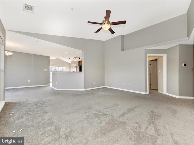 unfurnished living room with carpet floors, ceiling fan with notable chandelier, and vaulted ceiling