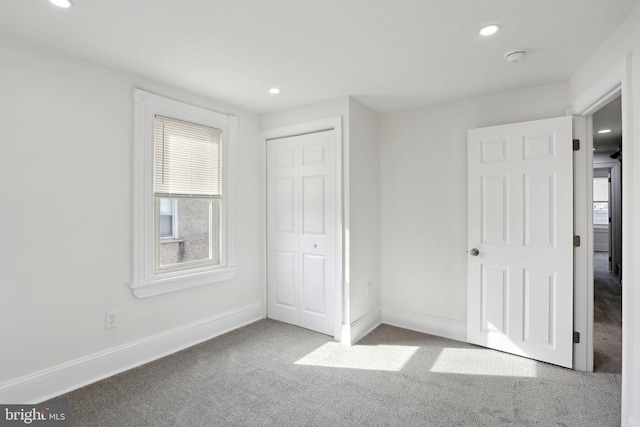 unfurnished bedroom featuring a closet and carpet