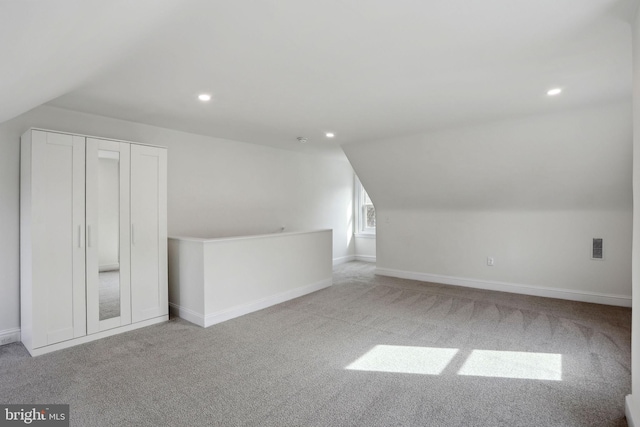 additional living space with lofted ceiling and light colored carpet