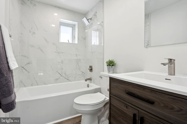 full bathroom featuring tiled shower / bath combo, vanity, and toilet