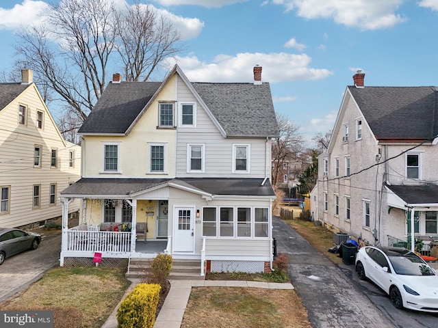 view of front facade with central AC and a porch