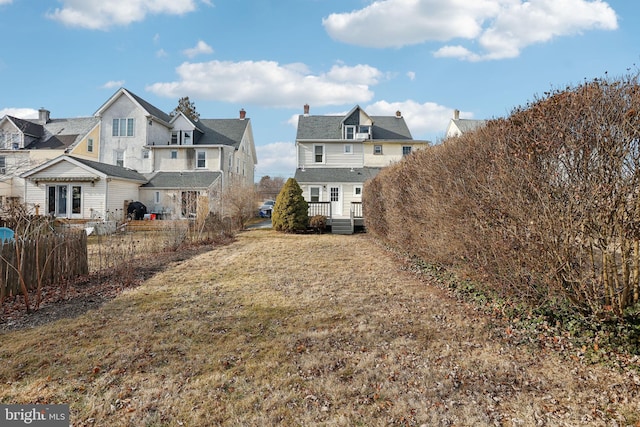 rear view of house featuring a lawn