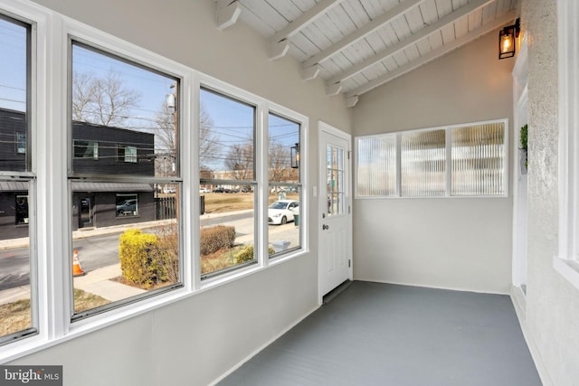 unfurnished sunroom with vaulted ceiling with beams and wooden ceiling