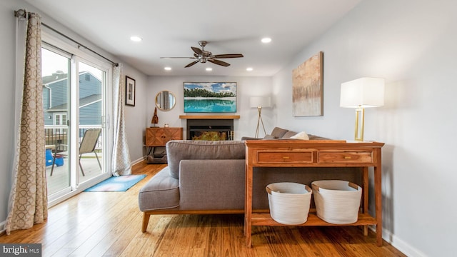 sitting room with hardwood / wood-style flooring and ceiling fan