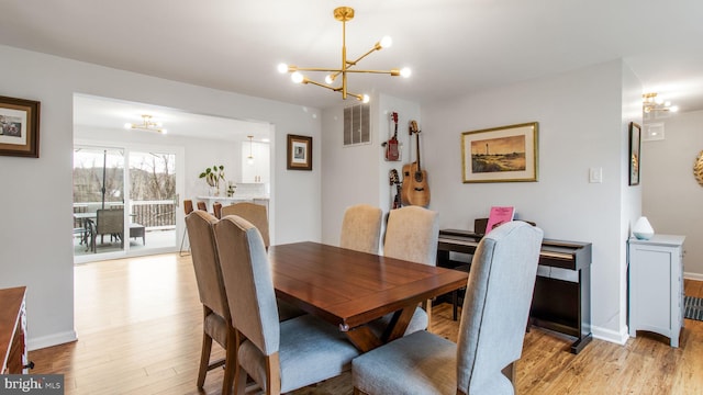 dining room featuring a chandelier and light hardwood / wood-style flooring