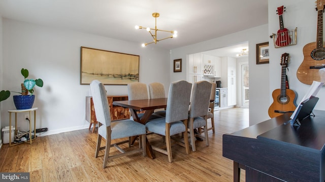 dining area with an inviting chandelier and light hardwood / wood-style floors