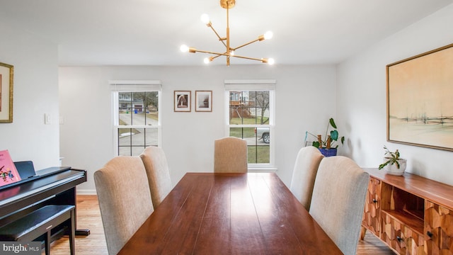 dining room featuring hardwood / wood-style floors and a chandelier