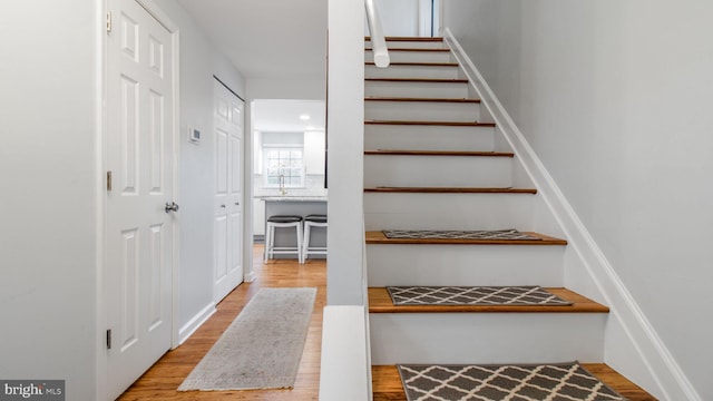 stairs featuring hardwood / wood-style flooring