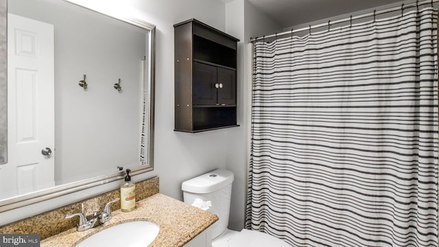 bathroom with vanity, toilet, and walk in shower