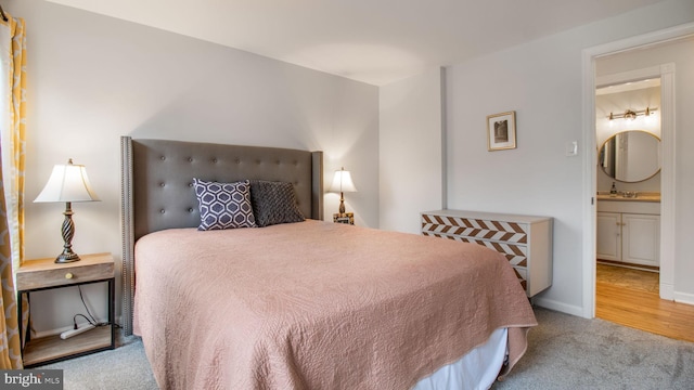 bedroom featuring sink and light colored carpet