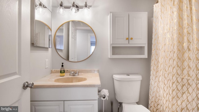 bathroom featuring vanity, toilet, and a shower with shower curtain