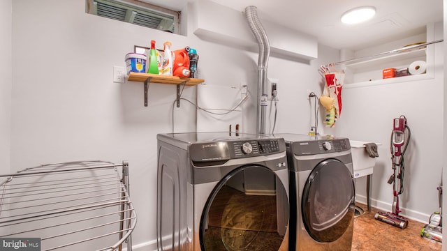 clothes washing area featuring washer and dryer