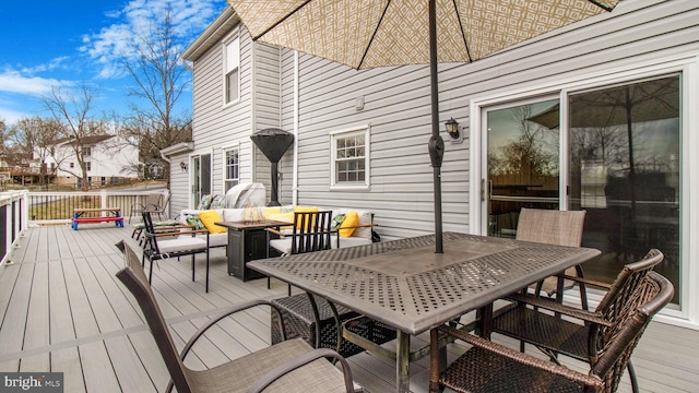 wooden deck with an outdoor fire pit