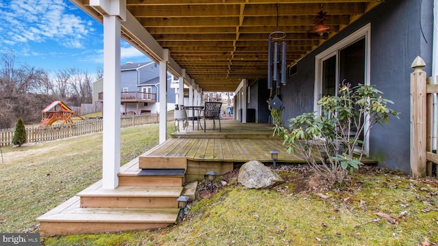 wooden deck with a lawn